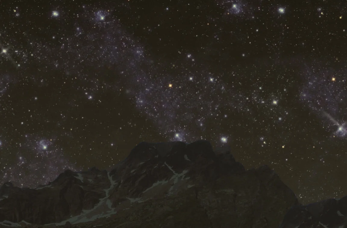 Starry night sky over a mountain range